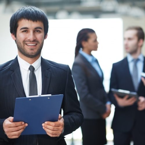 competitive-businessman-holding-clipboard_1098-1411