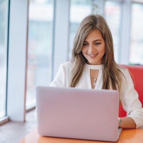 elegant-woman-with-smiling-face-typing-her-laptop_1157-1942